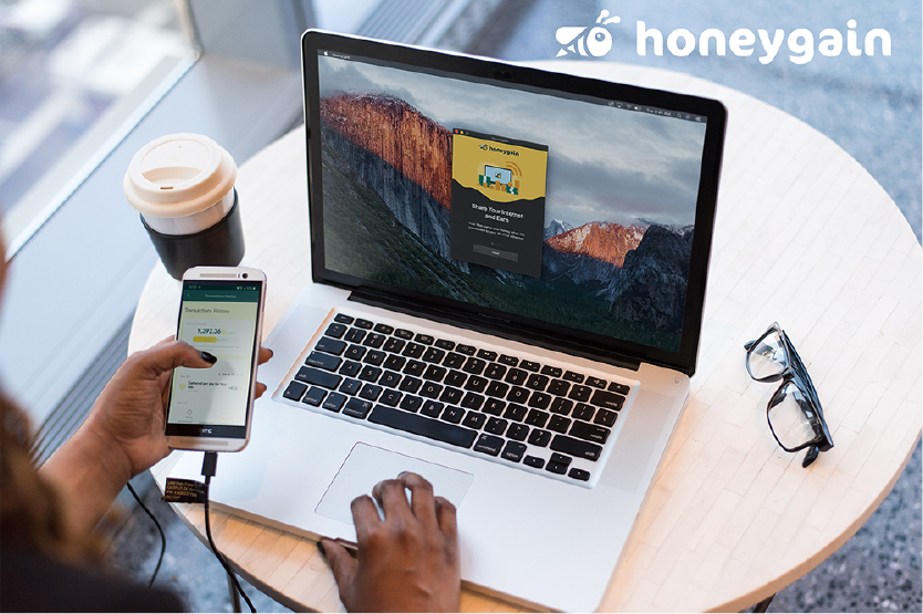 Cryptocurrency Holding phone in hand and computer on table